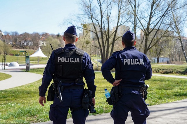 Funkcjonariusze policji w mundurach stojący tyłem – Dzień Policj